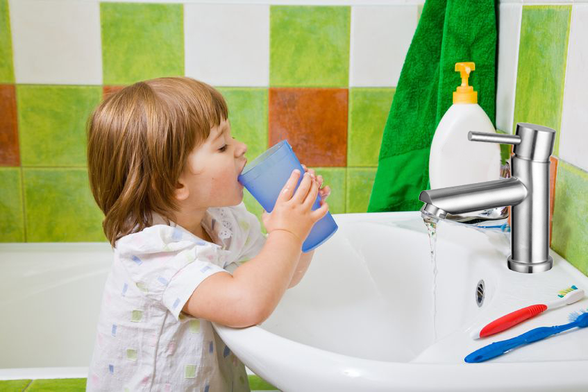 personal hygiene. the little girl rinses a mouth after toothbrushing.